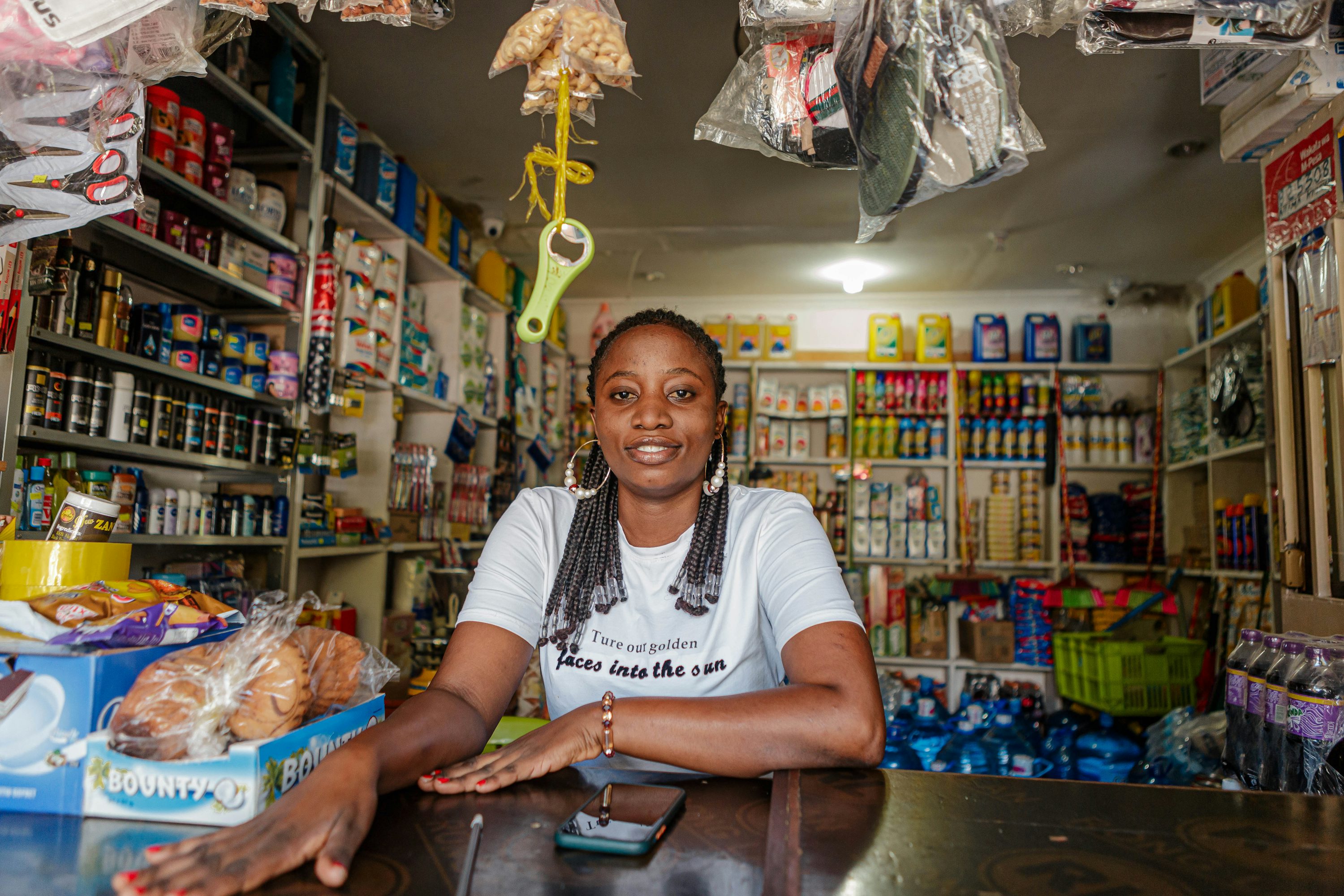 A merchant behind the counter of her shop in Dar es Salaam, Tanzania