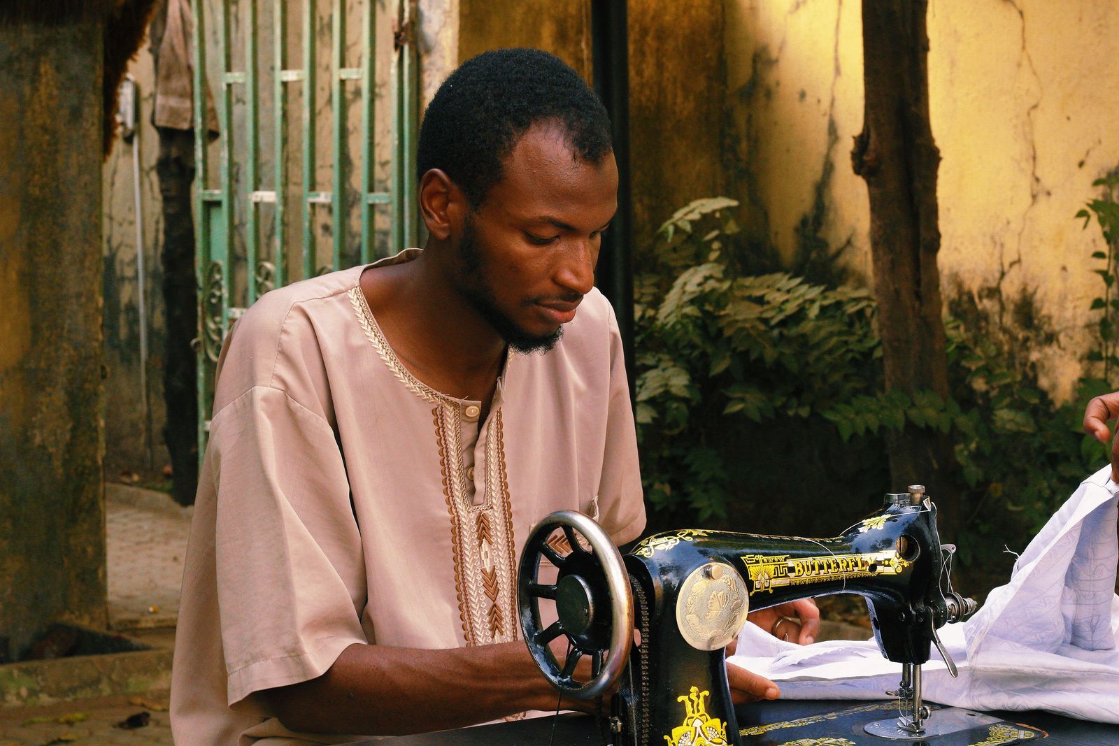 A tailor sewing a garment in Abuja, Nigeria
